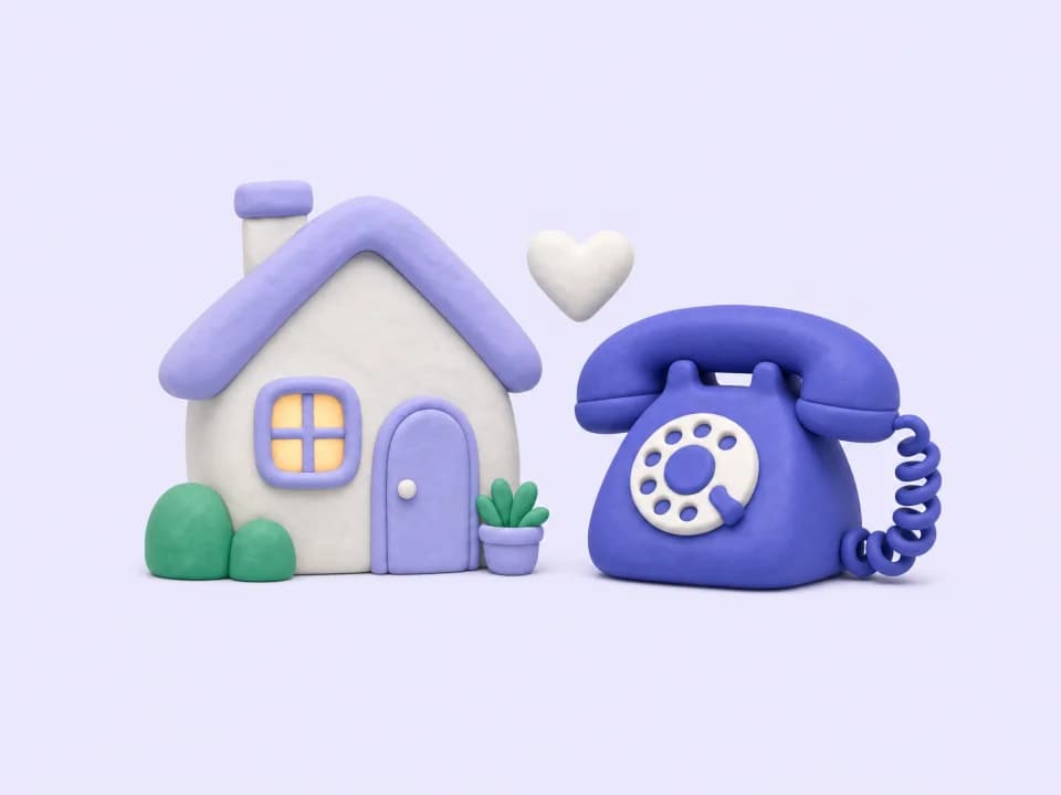 A small house next to a landline telephone, with a heart between them